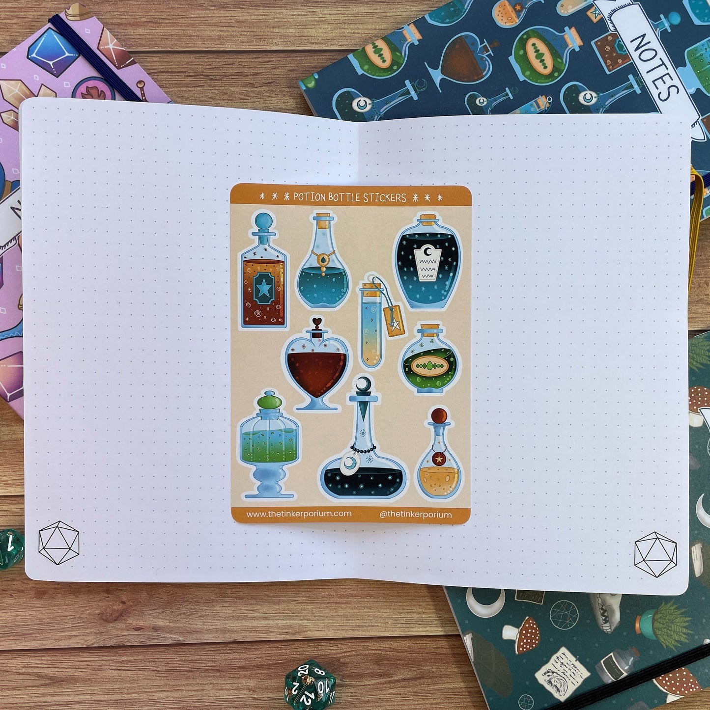 A6 Apothecary sticker set with 9 potion bottle paper stickers sat on an A5 notebook to show size
